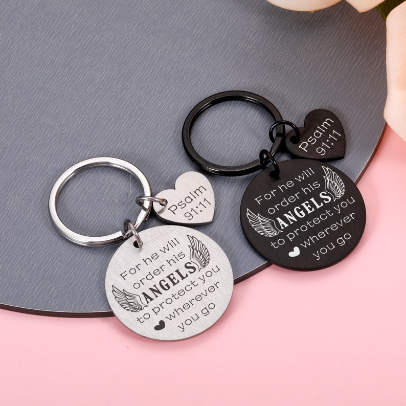 May include: Two silver keychains with a round charm that says "For he will order his angels to protect you wherever you go" and a heart charm that says "Psalm 91:11".
