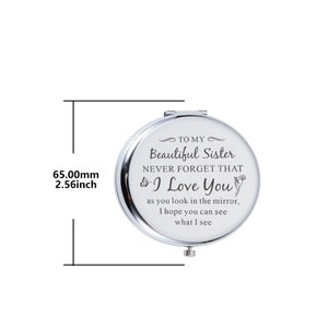 May include: A silver compact mirror with a message that reads "To my Beautiful Sister Never Forget That I Love You as you look in the mirror, I hope you can see what I see". The mirror is 2.56 inches in diameter.
