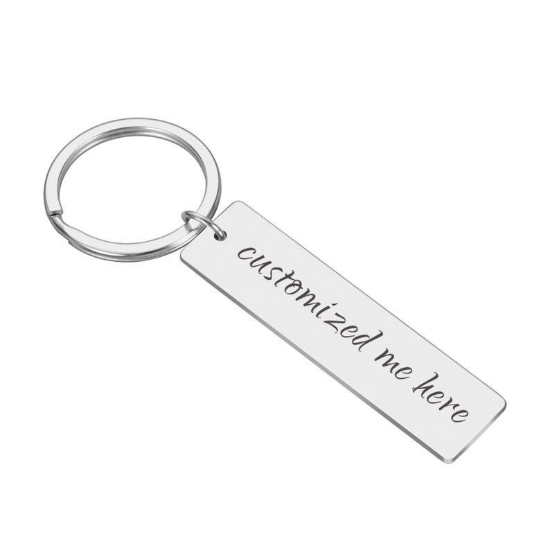 May include: Silver keyring with a rectangular tag that says "customized me here" in cursive.
