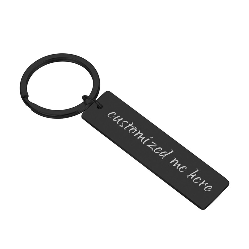 May include: Black metal keychain with a rectangular tag that says "customized me here" in white lettering.