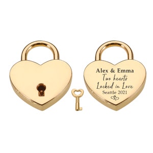 May include: Gold heart-shaped padlock with a key. The padlock has the inscription "Alex & Emma Two hearts Locked in Love Seattle 2021".