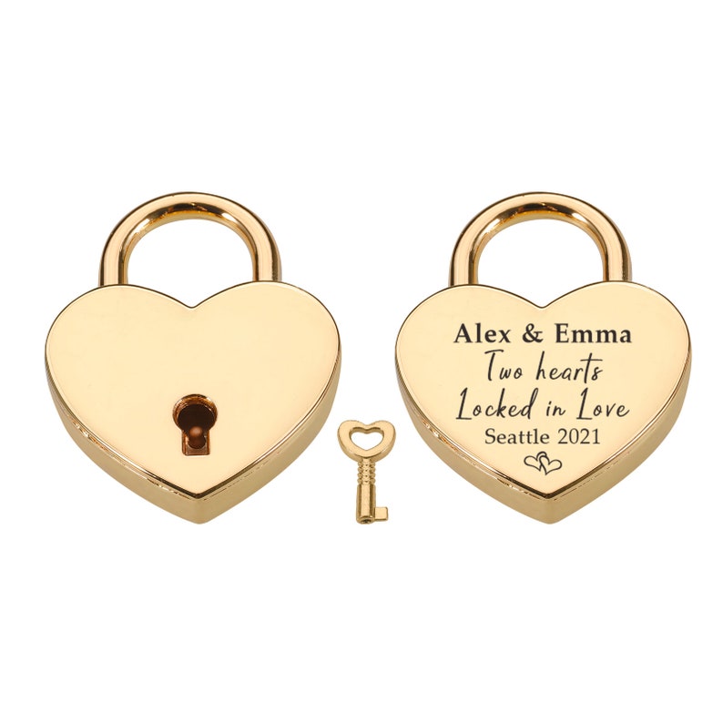 May include: Gold heart-shaped padlock with a key. The padlock has the inscription "Alex & Emma Two hearts Locked in Love Seattle 2021".
