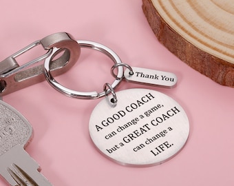 May include: A silver keychain with a round charm that reads "A good coach can change a game, but a great coach can change a life."  The charm is attached to a silver key ring with a silver lobster clasp.  There is a smaller silver tag attached to the key ring that reads "Thank You".