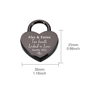 May include: Black heart-shaped padlock with the inscription "Alex & Emma Two hearts Locked in Love Seattle 2021". The padlock measures 1.18 inches wide and 0.98 inches tall.