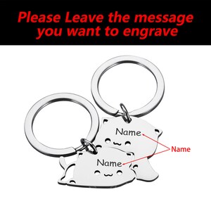 May include: Two silver keychains with cat-shaped charms. Each charm has a space for engraving a name. The text "Please Leave the message you want to engrave" is visible at the top of the image.