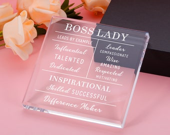 Puede incluir: Una placa de acrílico transparente con el texto "BOSS LADY" y una lista de atributos positivos, que incluyen "Líder", "Compasivo", "Sabio", "Increíble", "Respetado", "Motivador", "Inspirador", "Habilidoso", "Exitoso" y "Creador de diferencias".