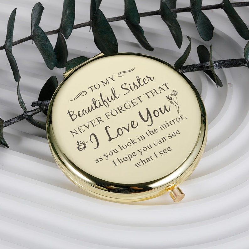 May include: Gold compact mirror with a message that reads "To my beautiful sister, never forget that I love you, as you look in the mirror, I hope you can see what I see."