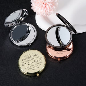 May include: Three compact mirrors with different colored frames: silver, black, and gold. The gold mirror has an engraved message: "To my Beautiful Sister Never Forget That I Love You as you look in the mirror, I hope you can see what I see."