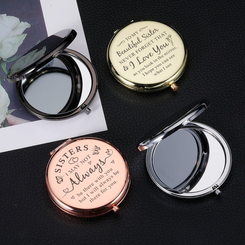 May include: Three compact mirrors with engraved messages. The first mirror is gold with the text "To my Beautiful Sister Never Forget That I Love You as you look in the mirror, I hope you can see what I see". The second mirror is rose gold with the text "Sisters I May Not Always be there with you but I will always be there for you". The third mirror is silver.