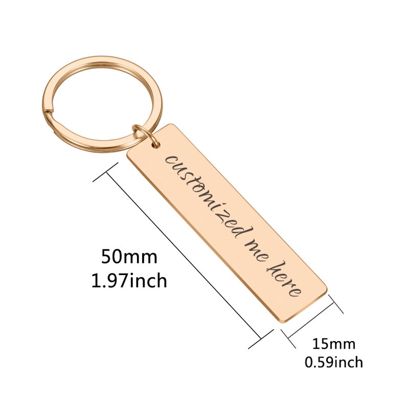 May include: Gold-toned metal keychain with a rectangular tag that reads "customized me here". The tag is 50mm long and 15mm wide.