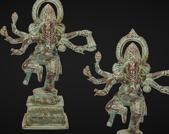 Puede incluir: Una estatua de metal verde y marrón de Ganesha, el dios hindú de la sabiduría y la prosperidad, con múltiples brazos y una trompa. La estatua está de pie sobre una base con intrincados tallados.