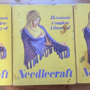 May include: Three yellow books with a blue and white patterned design on the cover. The books are titled "Leewards Complete Library of Needlecraft".