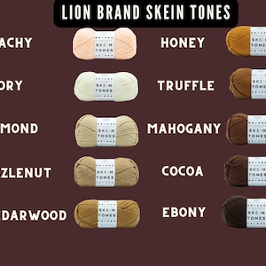 May include: A collection of Lion Brand Skein Tones yarn in various colors, including Peachy, Ivory, Almond, Hazlenut, Cedarwood, Honey, Truffle, Mahogany, Cocoa, and Ebony. Each skein is labeled with the "Skein Tones" brand.