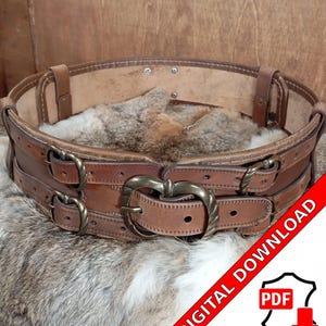 May include: A brown leather belt with two rows of heart-shaped buckles and a large, ornate buckle in the center. The belt is on a furry surface and the text "DIGITAL DOWNLOAD PDF" is visible in the lower right corner.