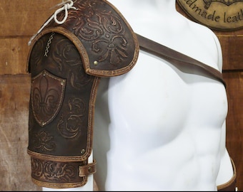 May include: A brown leather shoulder pauldron with embossed floral and fleur-de-lis designs. The armor includes a strap and is displayed on a white mannequin. The text "DIGITAL DOWNLOAD" is at the bottom.