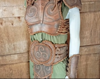 May include: A brown leather chest armor set featuring embossed spiral and triskelion patterns, shoulder pauldrons, a wide waist belt, and a forearm bracer, all secured with leather lacing. The text DIGITAL DOWNLOAD PATTERN&INSTRUCTIONS INCLUDED is visible.