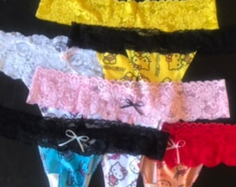 May include: A stack of six colorful lace thongs with Hello Kitty prints. The thongs are in various colors, including yellow, white, pink, black, blue, and red.
