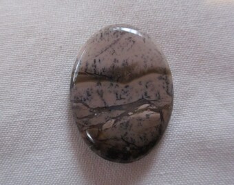 May include: A smooth, oval-shaped stone with a brown, gray, and white marbled pattern.