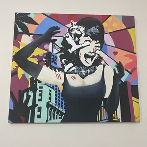 May include: A colorful pop art painting of a woman screaming, with black gloves and a black dress. The background features a cityscape and abstract shapes in various colors, including red, yellow, and blue. The woman's face is partially obscured by a white and black design.