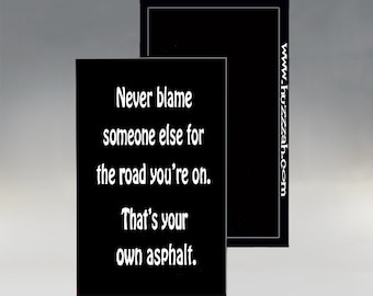 May include: Black and white motivational quote on a black background. The quote reads: "Never blame someone else for the road you're on. That's your own asphalt."