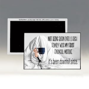 May include: A person under a white blanket holding a dark blue mug. The image includes the text: "NOT BEING BORN INTO A RICH FAMILY WAS MY FIRST FINANCIAL MISTAKE. It's been downhill since." The website address www.shark-bites.com is also visible.