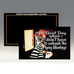 May include: A black and white striped pair of legs with red shoes, with the text "It's a Good Day when I didn't have to unleash the Flying Monkeys" on a black background.