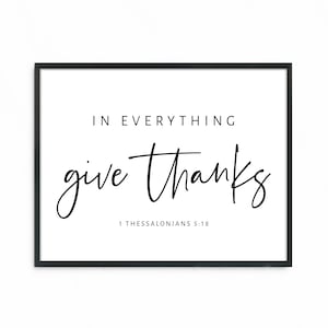 May include: Black and white typography print with the text "In everything give thanks" and the scripture reference "1 Thessalonians 5:18".