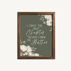 May include: A framed print with a green background and white floral design. The text reads "I trust the next chapter because I know the Author."