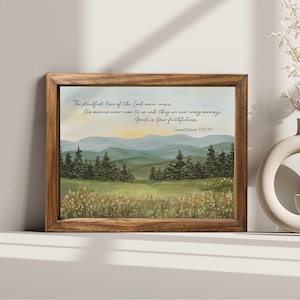 May include: A framed landscape art print featuring a serene mountain scene with a field of wildflowers and evergreen trees. The artwork includes the text "The steadfast love of the Lord never ceases...Great is Your faithfulness." in elegant script.