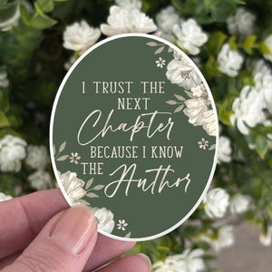 May include: A green and white round sticker with the text "I trust the next chapter because I know the Author" and floral designs.