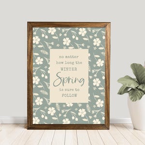 May include: Wooden framed wall art with a floral pattern background in a muted green color. The artwork features the text "no matter how long the WINTER Spring is sure to FOLLOW" in a cream-colored rectangle.