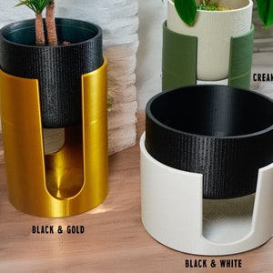 May include: Three plant stands with different color combinations: black and gold, black and white, and cream and green. The stands are made of a textured material and have a unique design that allows the plant pot to sit securely inside.