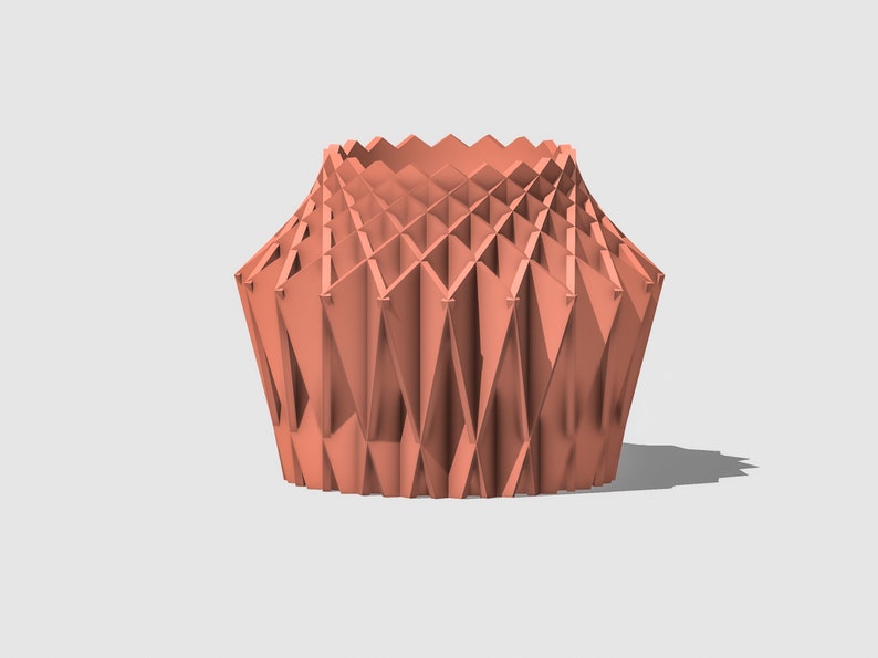 May include: A coral-coloured geometric vase with a unique folded design. The vase is made of a smooth, textured material and has a wide opening at the top.