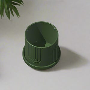 May include: A dark green ceramic planter with a geometric design. The planter has a wide base and a narrow opening.