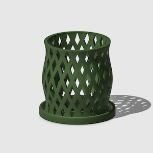 May include: A green, diamond-shaped planter with a wide base and a narrow top. The planter is made of a lightweight material and has a decorative design.