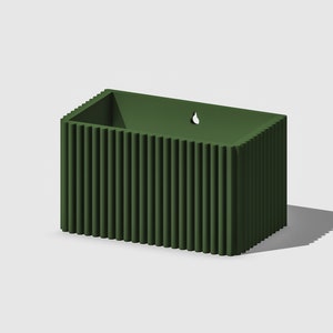May include: A dark green rectangular planter with vertical ridges. The planter has a drainage hole on the top.