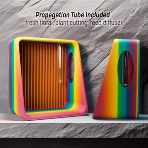 May include: Two rainbow-colored geometric plant propagation stands with clear glass tubes. The stands are made of plastic and have a striped pattern. The text "Propagation Tube Included" is written above the stands. The text "fresh floral, plant cutting, reed diffuser" is written below the stands.
