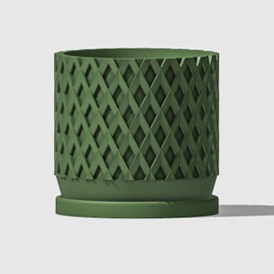 May include: A green ceramic planter with a geometric diamond pattern. The planter has a wide base and a slightly flared top.