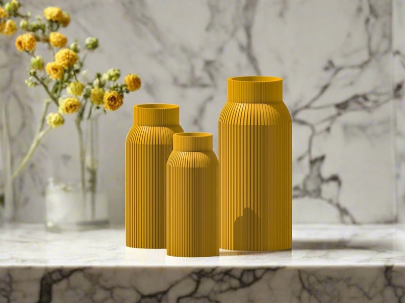 May include: Three yellow ceramic vases with a ribbed texture. The vases are arranged in a row from largest to smallest.