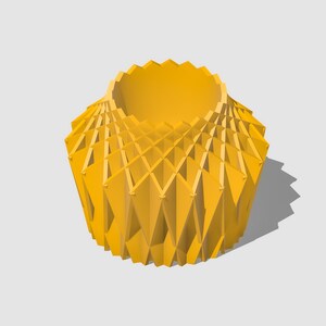 May include: A yellow geometric vase with a unique, intricate design. The vase is made of a series of overlapping triangles that create a three-dimensional effect.