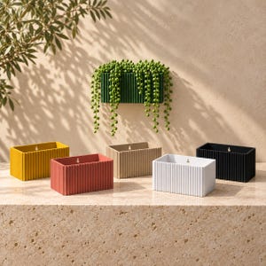 May include: A collection of rectangular wall-mounted planters featuring a vertical ribbed texture. The set includes individual units in mustard yellow, terracotta red, beige, white, and black, each with a small keyhole slot for mounting.
