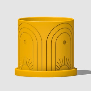 May include: A yellow ceramic planter with a geometric design featuring arches and sunbursts. The planter has a drainage hole and a matching saucer.