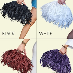May include: Four fringed handbags in black, white, vine-burgundy, and purple. Each bag has a rectangular shape with a handle and is decorated with long, flowing fringe. The words "BLACK", "WHITE", "VINE-BURGUNDY", and "PURPLE" are displayed below each bag.