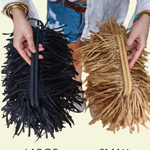 May include: Two fringed handbags, one black and one tan, are displayed. The black bag is labelled "LARGE" and the tan bag is labelled "SMALL". Both bags have a woven handle and a fringe design.