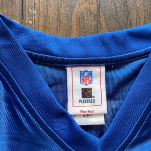 May include: A blue NFL Players Inc. jersey tag with the text "For Her" and "S/P/P".