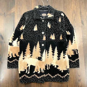 May include: Black button-down jacket with a forest and wildlife design. The jacket features a pattern of tan trees, bears, and moose against a black background. White dots are scattered across the top portion of the jacket.