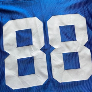 May include: A blue jersey with the number 88 printed in white on the back.