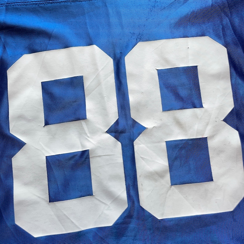 May include: A blue jersey with the number 88 printed in white on the back.