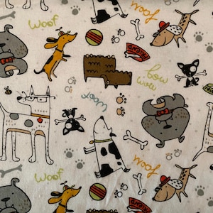 May include: White fabric featuring a repeating pattern of cartoon dogs in various poses. The dogs are in shades of grey, brown, and black, with accents of yellow and red. Scattered around are bones, paw prints, and the word "Woof".