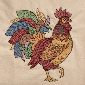 May include: A colorful embroidered rooster with a detailed design. The rooster is standing on a white background.